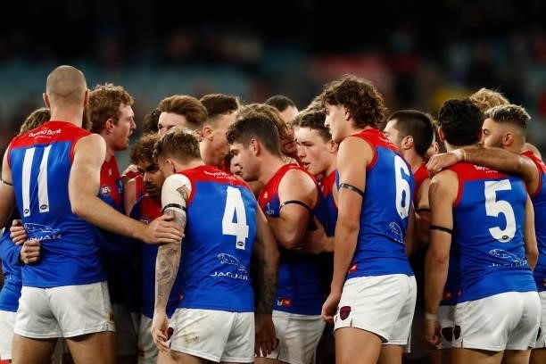 Melbourne huddle up during the round 15 AFL match between the Essendon Bombers and the Melbourne Demons at Melbourne Cricket Ground on June 26, 2021...
