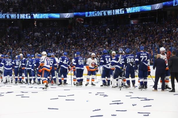 The New York Islanders and the Tampa Bay Lightning shake hanks following Game Seven of the NHL Stanley Cup Semifinals during the 2021 Stanley Cup...