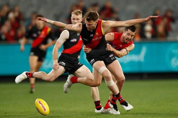 Alex Neal-Bullen of the Demons tackles Jordan Ridley of the Bombers during the round 15 AFL match between the Essendon Bombers and the Melbourne...