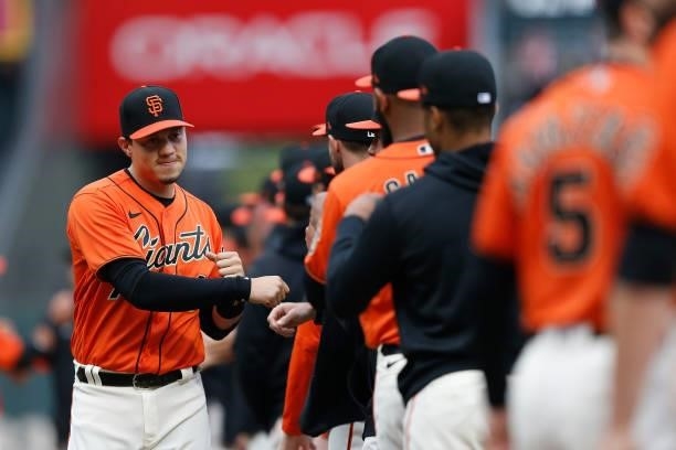 Wilmer Flores of the San Francisco Giants high-fives teammates during player introductions before the game against the Oakland Athletics at Oracle...