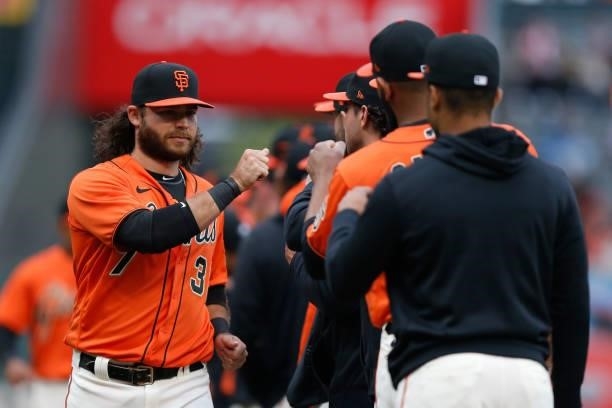 Brandon Crawford of the San Francisco Giants high-fives teammates during player introductions before the game against the Oakland Athletics at Oracle...