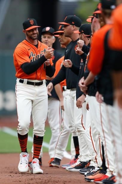 Gabe Kapler manager of the San Francisco Giants high-fives players during player introductions before the game against the Oakland Athletics at...