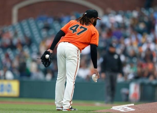 Johnny Cueto of the San Francisco Giants uses the rosin bag while pitching against the Oakland Athletics at Oracle Park on June 25, 2021 in San...