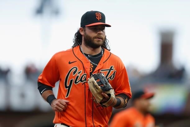 Brandon Crawford of the San Francisco Giants jogs to the dugout between innings against the Oakland Athletics at Oracle Park on June 25, 2021 in San...