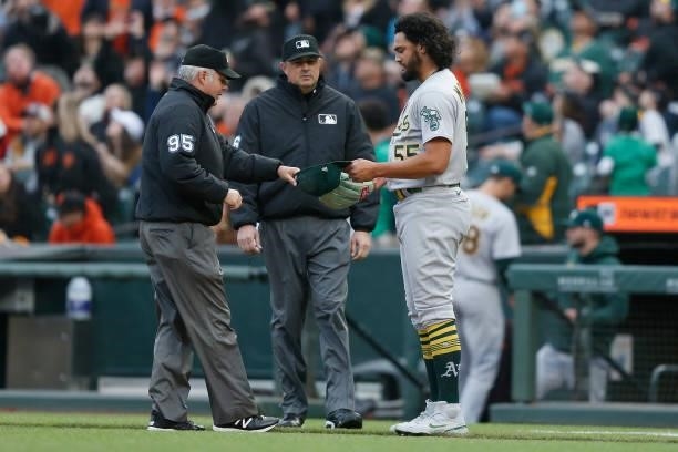 Sean Manaea of the Oakland Athletics has his glove and hast inspected by umpire Tim Timmons at Oracle Park on June 25, 2021 in San Francisco,...