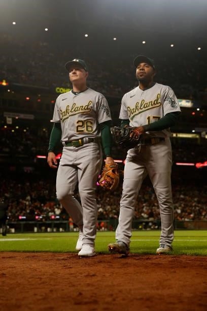 Infielders Matt Chapman and Elvis Andrus of the Oakland Athletics walks to the dugout during the game against the San Francisco Giants at Oracle Park...