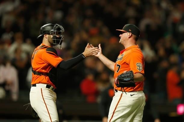Catcher Curt Casali and pitcher Jake McGee of the San Francisco Giants celebrate after a win against the Oakland Athletics at Oracle Park on June 25,...