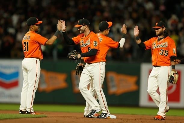 LaMonte Wade Jr, Steven Duggar, Mauricio Dubon and Brandon Crawford of the San Francisco Giants celebrate after a win against the Oakland Athletics...