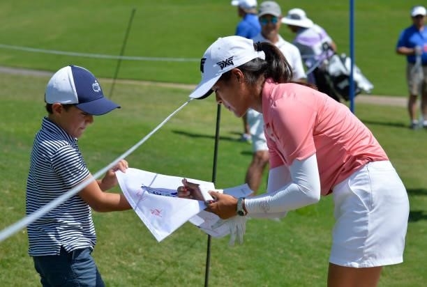 Celine Boutier of France signs a flag for a young fan on the 18th green during the third round of the KPMG Women's PGA Championship at Atlanta...