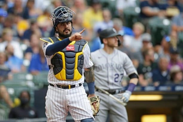 Omar Narvaez of the Milwaukee Brewers looks toward the dugout against the Colorado Rockies at American Family Field on June 25, 2021 in Milwaukee,...