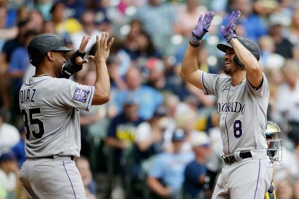 Joshua Fuentes of the Colorado Rockies is congratulated by Elias Diaz after hitting a two run homer against the Milwaukee Brewers at American Family...