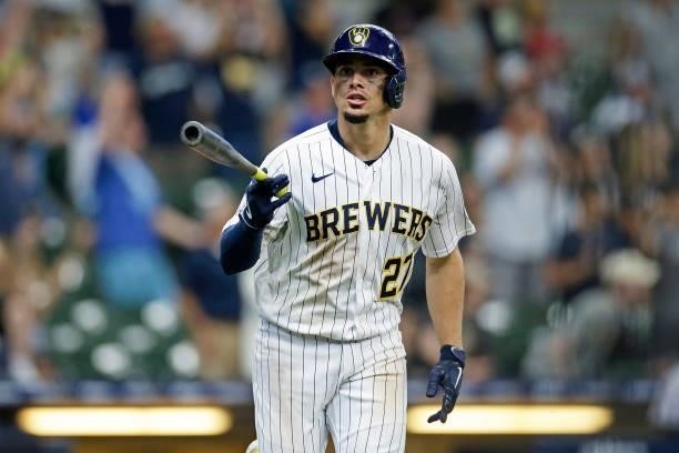 Willy Adames of the Milwaukee Brewers looks toward the Brewers bench and flips his bat after hitting a two run homer in the ninth inning to tie the...