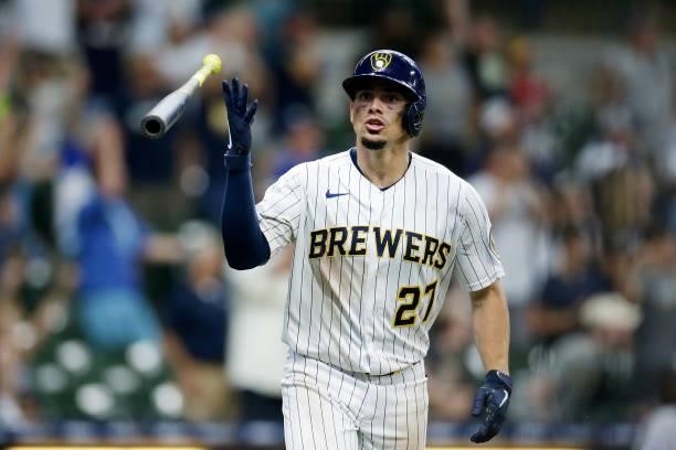 Willy Adames of the Milwaukee Brewers looks toward the Brewers bench and flips his bat after hitting a two run homer in the ninth inning to tie the...