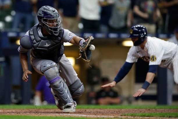 Yonathan Daza of the Colorado Rockies catches a throw to the plate against the Milwaukee Brewers at American Family Field on June 25, 2021 in...