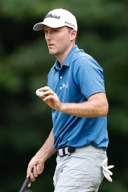 Russell Henley of the United States reacts to a putt on the 14th green during the third round of the Travelers Championship at TPC River Highlands on...