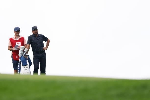 Jason Day of Australia talks with his caddie on the 14th hole during the third round of the Travelers Championship at TPC River Highlands on June 26,...