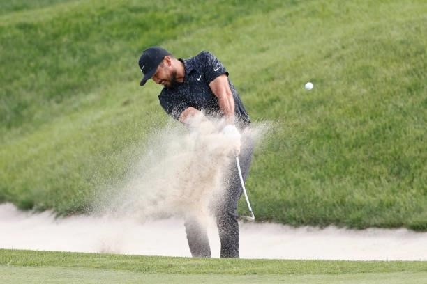 Jason Day of Australia plays a shot from a bunker on the 18th hole during the third round of the Travelers Championship at TPC River Highlands on...
