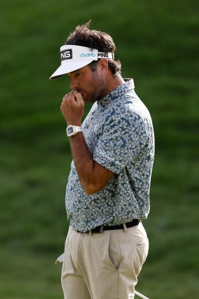 Bubba Watson of the United States reacts to his missed birdie putt on the 18th green during the third round of the Travelers Championship at TPC...