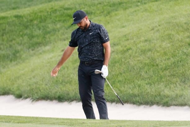 Jason Day of Australia reacts to his shot on the 18th hole during the third round of the Travelers Championship at TPC River Highlands on June 26,...