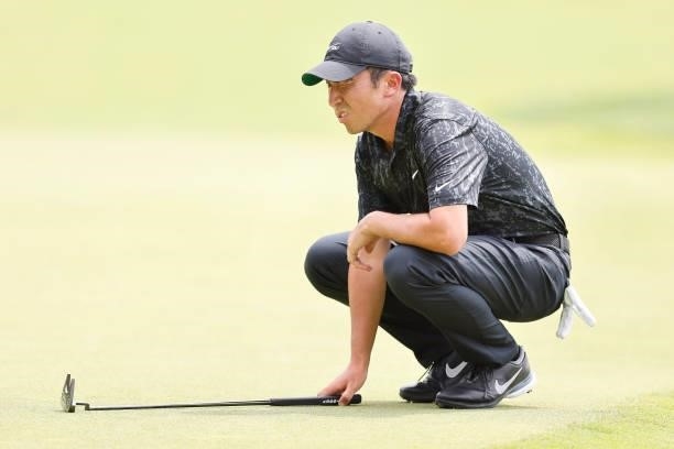 Doug Ghim of the United States looks over a putt on the seventh green during the third round of the Travelers Championship at TPC River Highlands on...