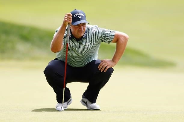 Brian Stuard of the United States looks over a putt on the seventh green during the third round of the Travelers Championship at TPC River Highlands...