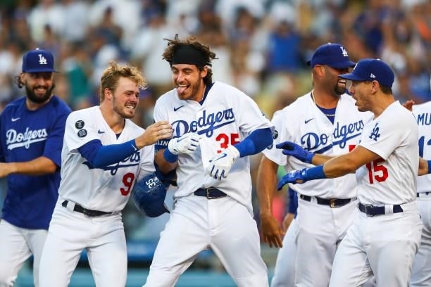 Cody Bellinger of the Los Angeles Dodgers celebrates his walk-off home run against the Chicago Cubs with teammates in the ninth inning at Dodger...