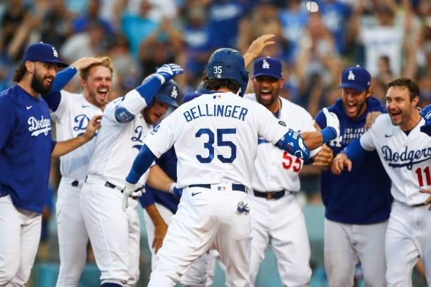 Cody Bellinger of the Los Angeles Dodgers celebrates his walk-off home run against the Chicago Cubs with teammates in the ninth inning at Dodger...