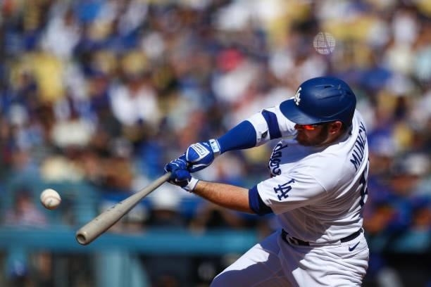 Max Muncy of the Los Angeles Dodgers hits a double to bring home Mookie Betts in the first inning against the Chicago Cubs at Dodger Stadium on June...