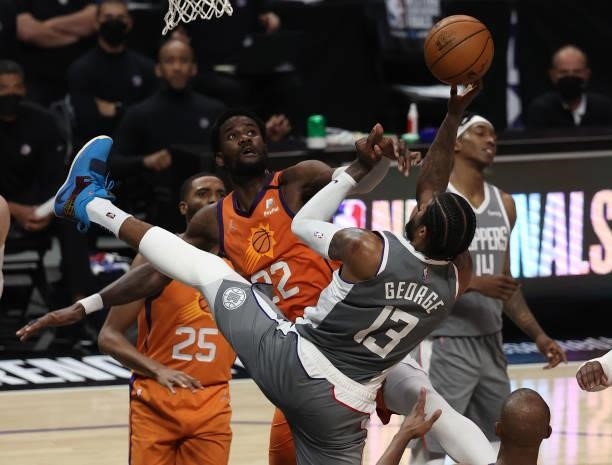 Paul George of the LA Clippers goes up for a shot against Deandre Ayton of the Phoenix Suns during the second half in game four of the Western...