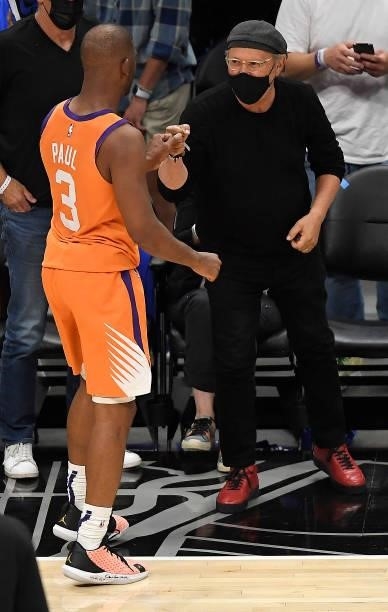Chris Paul of the Phoenix Suns celebrates a win against the LA Clippers with actor Billy Crystal in game four of the Western Conference Finals at...