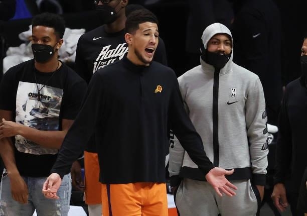 Devin Booker of the Phoenix Suns reacts on the bench against the LA Clippers during the second half in game four of the Western Conference Finals at...