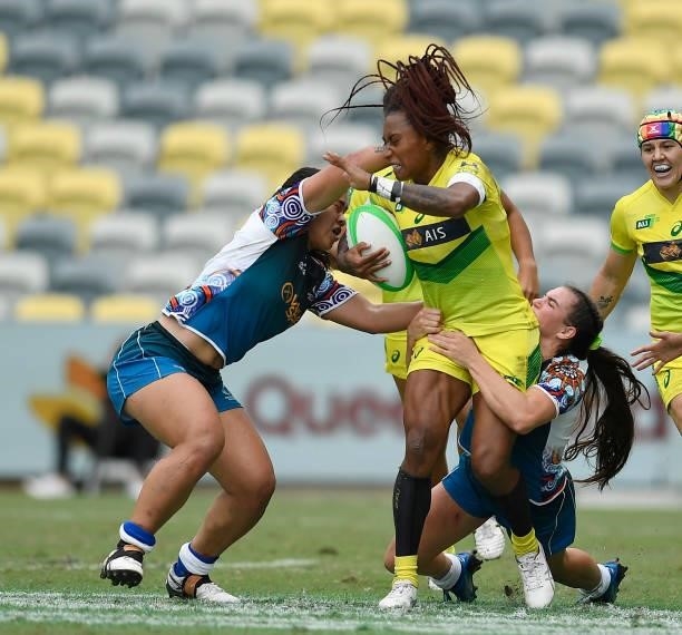 Ellia Green of Australia is tackled during the Oceania Sevens Challenge match between Australia and Oceania at Queensland Country Bank Stadium on...
