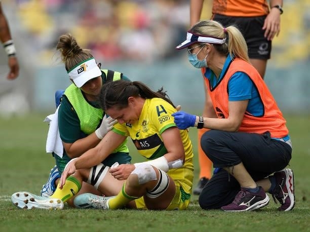 Chloe Dalton of Australia receives treatment after being injured during the Oceania Sevens Challenge match between Australia and Oceania at...