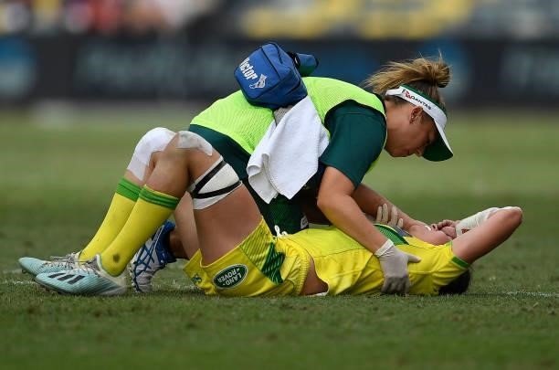 Chloe Dalton of Australia receives treatment after being injured during the Oceania Sevens Challenge match between Australia and Oceania at...