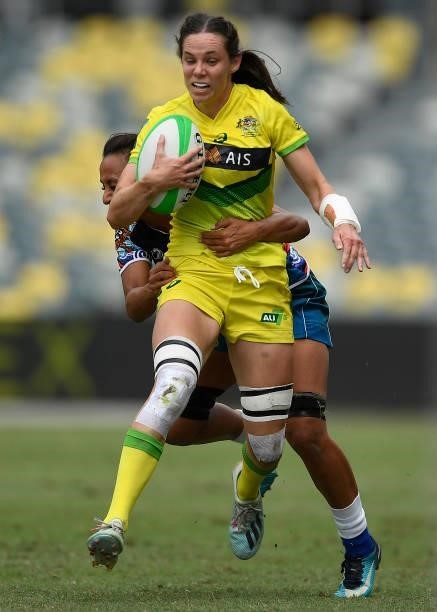 Chloe Dalton of Australia is tackled during the Oceania Sevens Challenge match between Australia and Oceania at Queensland Country Bank Stadium on...