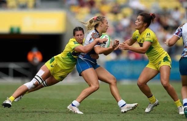 Teahan Levi of Oceania is tackled by Demi Hayes and Madison Higgins-Ashby of Australia during the Oceania Sevens Challenge match between Australia...