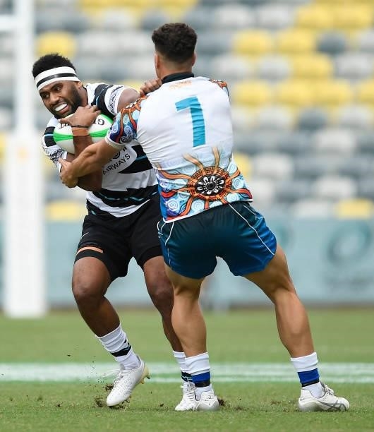 Vilimoni Botitu of Fiji is tackled by Mark Nawaqanitawase of Oceania during the Oceania Sevens Challenge match between Fiji and Oceania at Queensland...