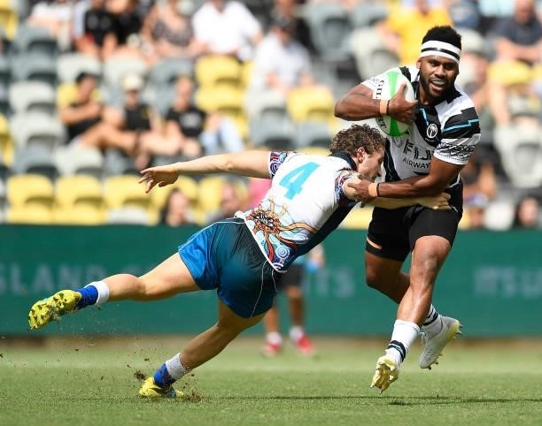 Vilimoni Botitu of Fiji is tackled by Jack Hayson of Oceania during the Oceania Sevens Challenge match between Fiji and Oceania at Queensland Country...
