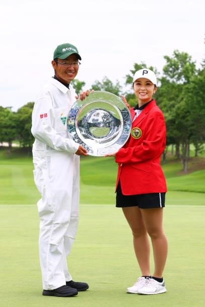Erika Kikuchi of Japan poses with the trophy and her caddie after winning the tournament following the final round of the Earth Mondamin Cup at...