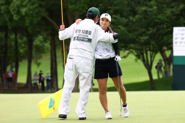 Erika Kikuchi of Japan celebrates with her caddie after winning the tournament on the 18th green during the final round of the Earth Mondamin Cup at...