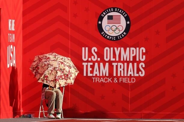 Person sits under an umbrella as air temperatures exceed 99-degrees on day nine of the 2020 U.S. Olympic Track & Field Team Trials at Hayward Field...