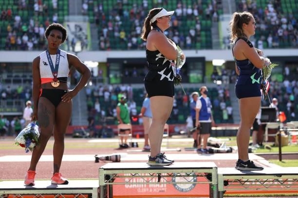 Gwendolyn Berry , third place, turns away from U.S. Flag during the U.S. National Anthem as DeAnna Price , first place, and Brooke Andersen, second...