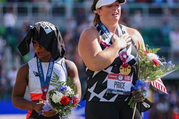 Gwendolyn Berry , third place, turns away from U.S. Flag during the U.S. National Anthem as DeAnna Price , first place, also stands on the podium...