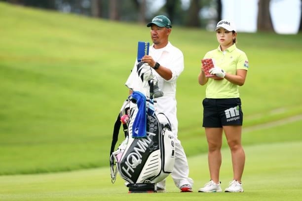 Momo Yoshikawa of Japan checks her yardage book on the 10th hole during the final round of the Earth Mondamin Cup at Camellia Hills Country Club on...