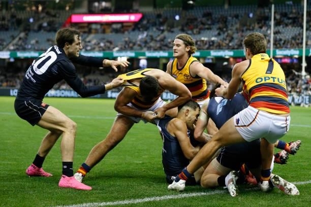 Carlton and Adelaide Crows players wrestle after a late hit of Jacob Weitering of the Blues during the round 15 AFL match between the Carlton Blues...
