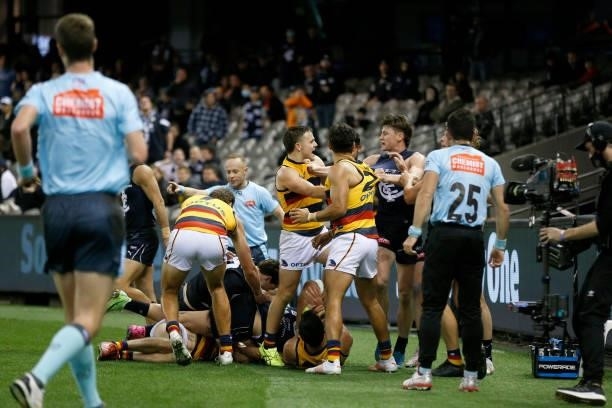 Carlton and Adelaide Crows players wrestle after a late hit of Jacob Weitering of the Blues during the round 15 AFL match between the Carlton Blues...