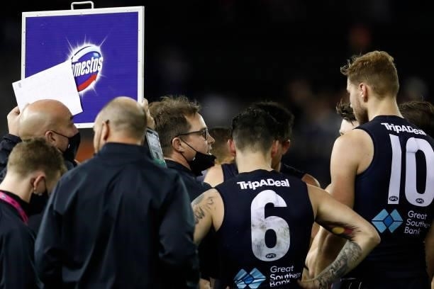 David Teague, senior coach of Carlton speaks to his players at the 3/4 time huddle during the round 15 AFL match between the Carlton Blues and the...