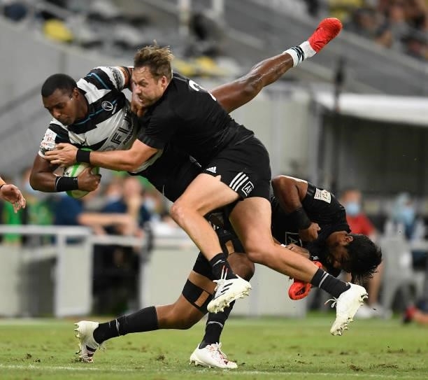 Josua Vakurunabili of Fiji is tackled by Tim Mikkelson of New Zealand during the Oceania Sevens Challenge match between New Zealand and Fiji at...