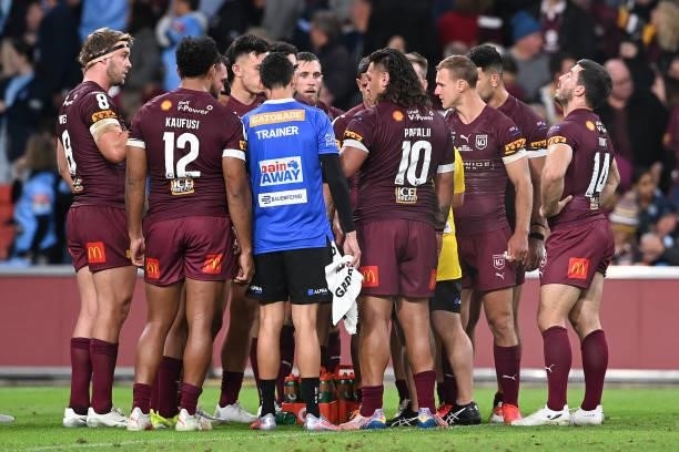 Maroons players are seen in a huddle during game two of the 2021 State of Origin series between the Queensland Maroons and the New South Wales Blues...
