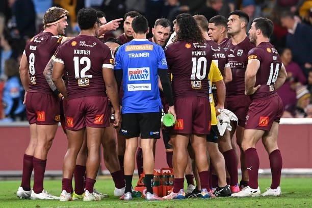 Maroons players are seen in a huddle during game two of the 2021 State of Origin series between the Queensland Maroons and the New South Wales Blues...